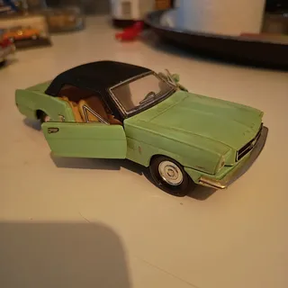 Grøn modelbil med sorte vinduer og åbne døre